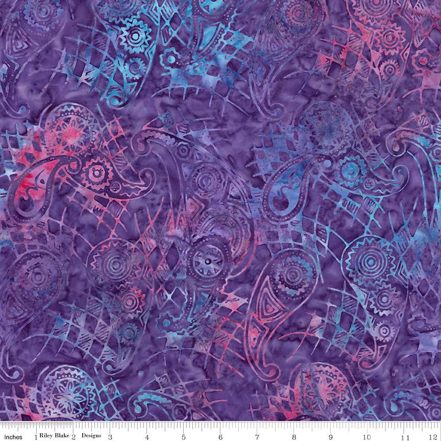 Mottled purple fabric with blue and pink paisley motifs and fine geometric lines; ruler along the bottom.
